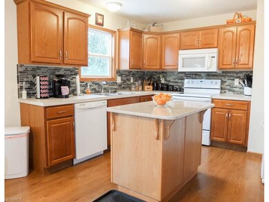Kitchen has a center island with solid surface cou