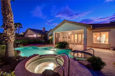 View of pool with a patio area and a pool with con