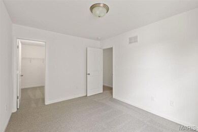 Unfurnished bedroom featuring carpet floors and a spacious closet