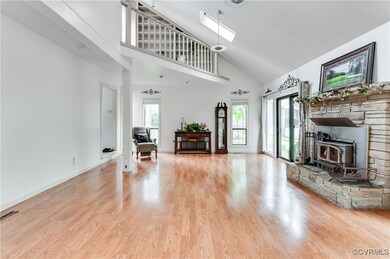 Living room featuring high vaulted ceiling, a wood