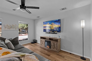 Living room with wood finished floors, a glass co