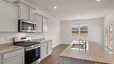 Kitchen with dark hardwood / wood-style flooring, 