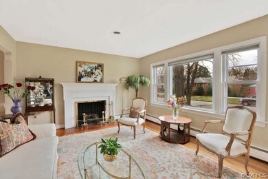 Living room view showing picture window. Custom blinds, wood floors.