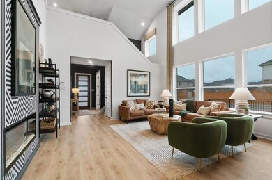 Living area featuring a towering ceiling, wood fi