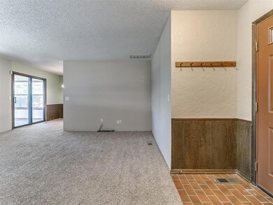 Unfurnished room with a textured ceiling, wooden w