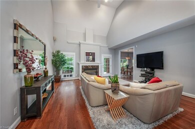 The great room boasts tall vaulted ceilings and a fireplace