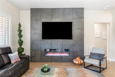 Living area featuring a tile fireplace, and basebo