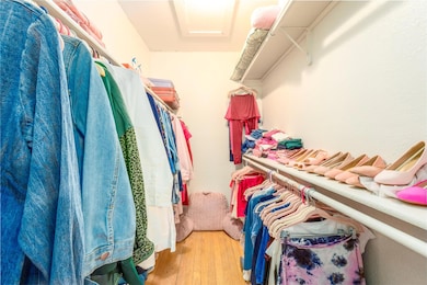 Spacious closet with light wood-style floors