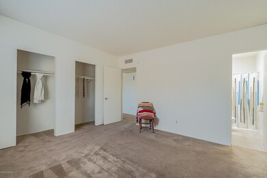 Master bedroom, separate closet spaces.