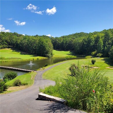 View of home's community golf course with a water 