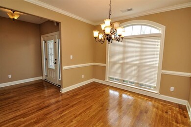 The formal dining room is just off the entry and offers the ideal setting for any holiday gathering. It features an elegant chandelier, smooth ceilings, and crown and chair moldings.