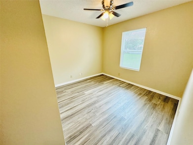 Unfurnished room with wood finished floors, a cei