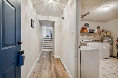 Come inside- laundry and garage downstairs and stairs to living space. Newer garage door opener,(2019) springs (2022) and water heater (2020)