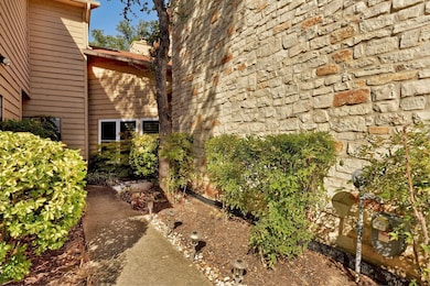 View of side of home with a chimney and stone sid