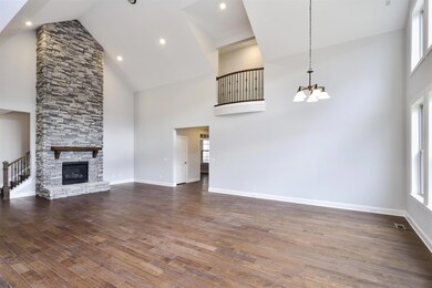 Hargrove- 2 story great room with stone fireplace and juliet balcony. Photo for representation purposes only. 