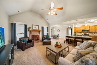 living room with valted ceiling and gas fireplace