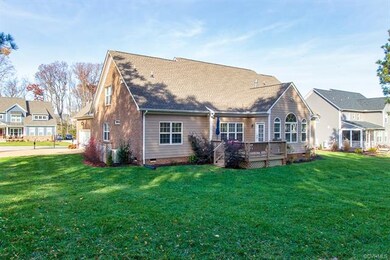 Nice size deck overlooking plush backyard.  The ba