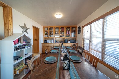 Dining space featuring a textured ceiling and dark wood finished floors