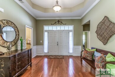 Wide and welcoming foyer with hardwood flooring.
