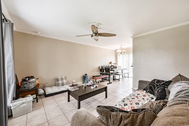 The living room has crown molding, tile floors and