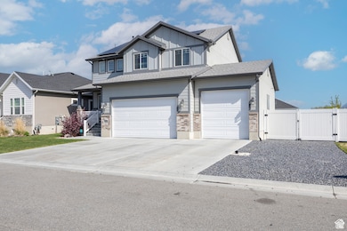 View of front of home featuring a gate, roof mounted solar panels, concrete driveway, and board and batten siding