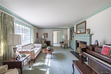 Living room featuring ornamental molding and carpet flooring