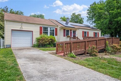View of front of home featuring solar panels, a de