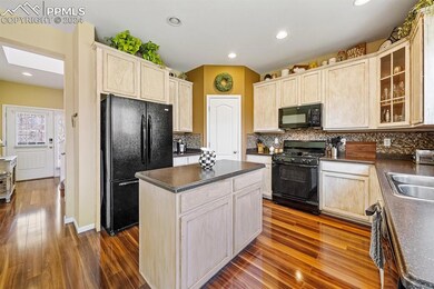 Kitchen with a center island, sink, backsplash, ha
