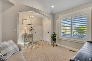 Carpeted foyer entrance with baseboards and recessed lighting
