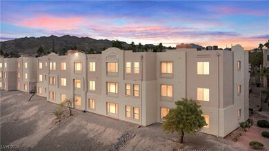 View of the back of the home's building at dusk