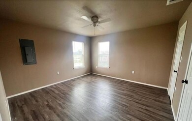 Spare room with dark wood finished floors, baseboa
