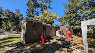 Back of house featuring a lawn