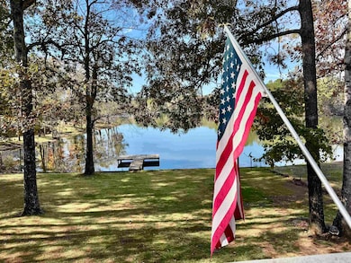 View of playground with a yard and a water view