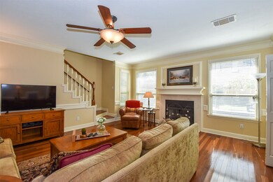 Living room with stairs, double pane windows, wood