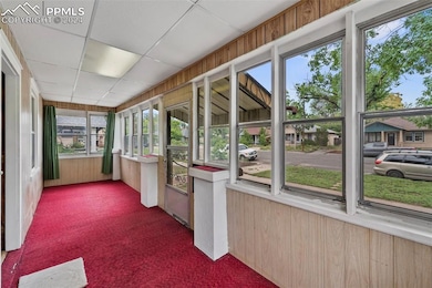 Unfurnished sunroom featuring a drop ceiling