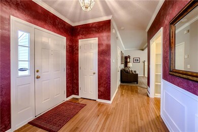 Entrance foyer featuring crown molding and light wood finished floors