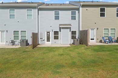 Back of house with a patio area and a lawn
