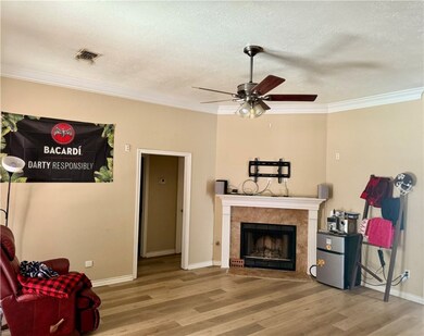 Living room with wood finished floors, ceiling fan