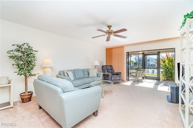Living room featuring carpet flooring & water view.