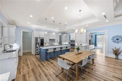 Open kitchen offers informal seating at the island and formal dining area.