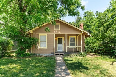 Bungalow-style house with covered porch, a front yard, and a chimney