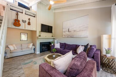 LIVING ROOM WITH COZY FIREPLACE.
