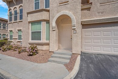 Doorway to property with a garage and stucco sidin