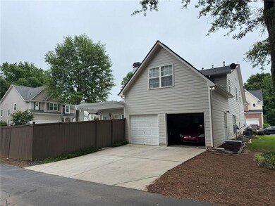 View of home's exterior with a garage, concrete driveway, and a chimney