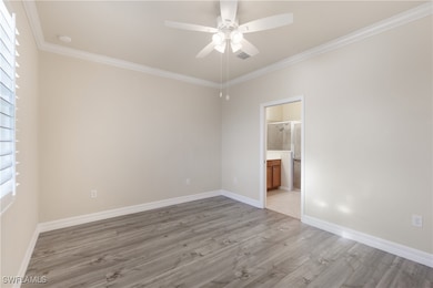 Primary room with ornamental molding, light wood-style flooring, a ceiling fan, and plenty of natural light