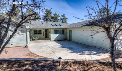 Rear view of property with driveway, a patio, and 