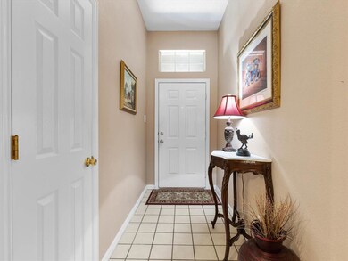 Tiled entry way with a coat closet.