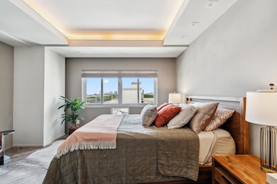 Serene bedroom with soft western light, tray ceili