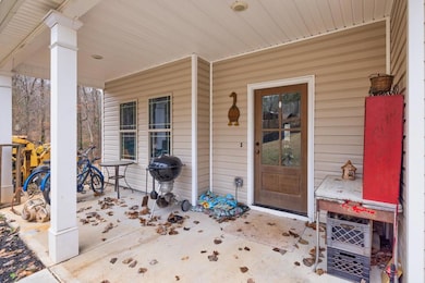 Traditional home with a porch, driveway, a front y