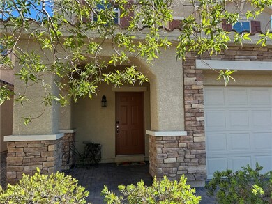 View of exterior entry with an attached garage, st
